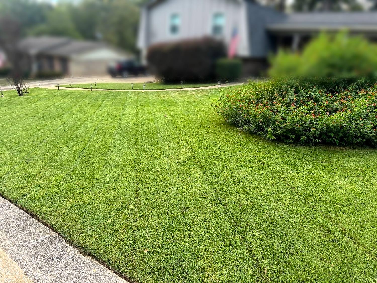 Freshly striped front lawn maintained by Summit Landscaping